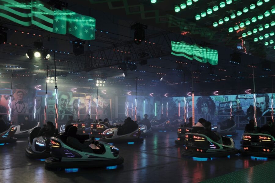 Indoor bumper car attraction with vibrant lights and flags in Hamburg, creating a fun atmosphere.